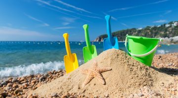 Family vacation with toys in the sand