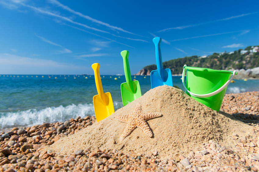 Family vacation with toys in the sand